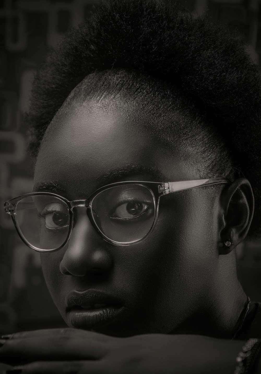 grayscale photo of boy wearing eyeglasses