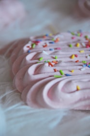 A close-up of a pastel-colored dessert with decorative details.