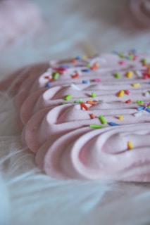 A close-up of a pastel-colored dessert with decorative details.