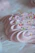 A close-up of a creamy lemon carlota dessert with a soft pink background.