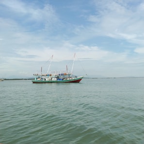 A fishing vessel equipped with ltran llc satellite communication antennas under a clear blue sky
