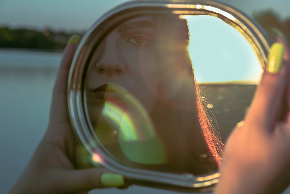 woman taking photo of her reflection on mirror