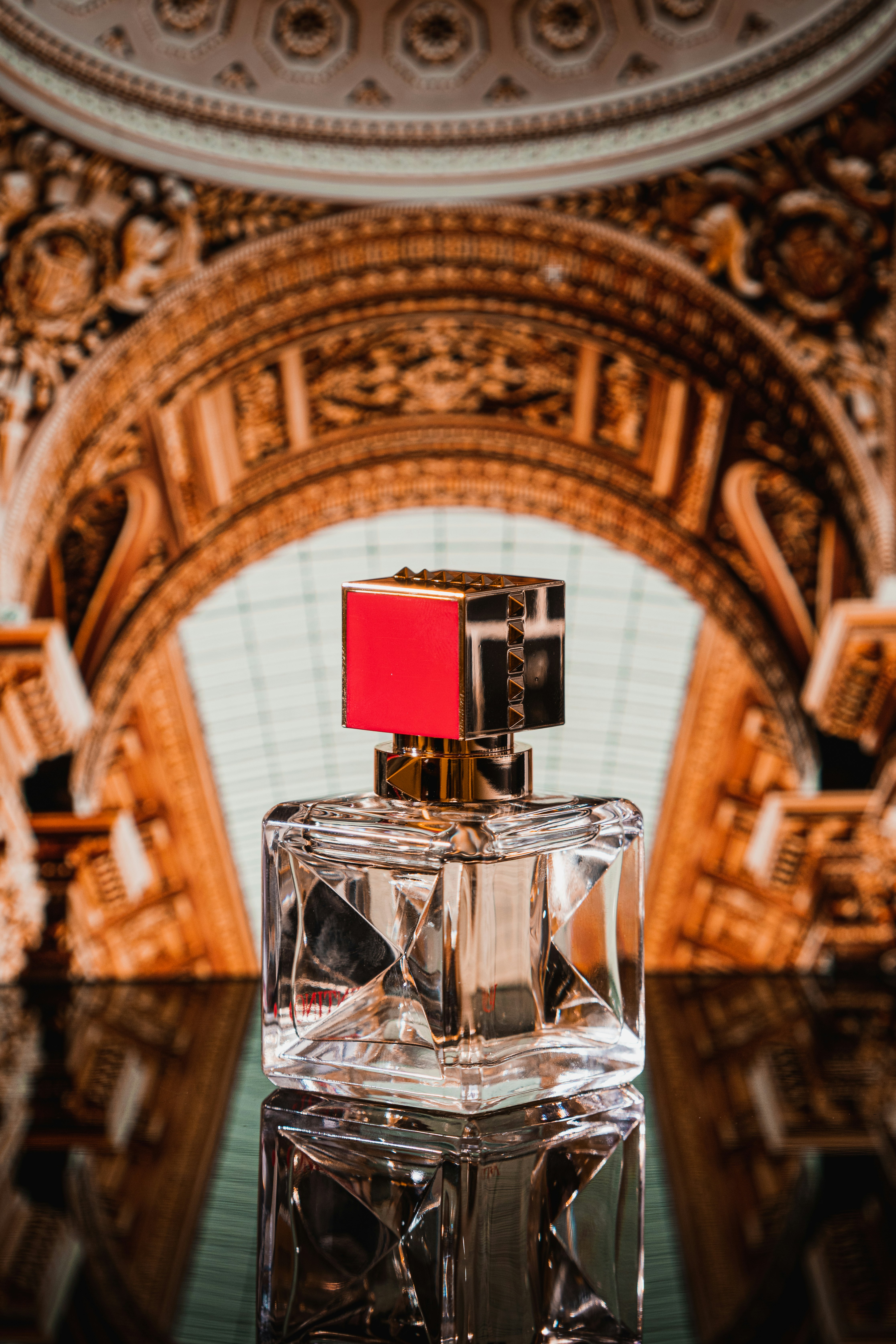 red and white glass perfume bottle