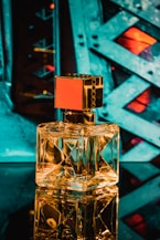 clear glass perfume bottle on blue surface
