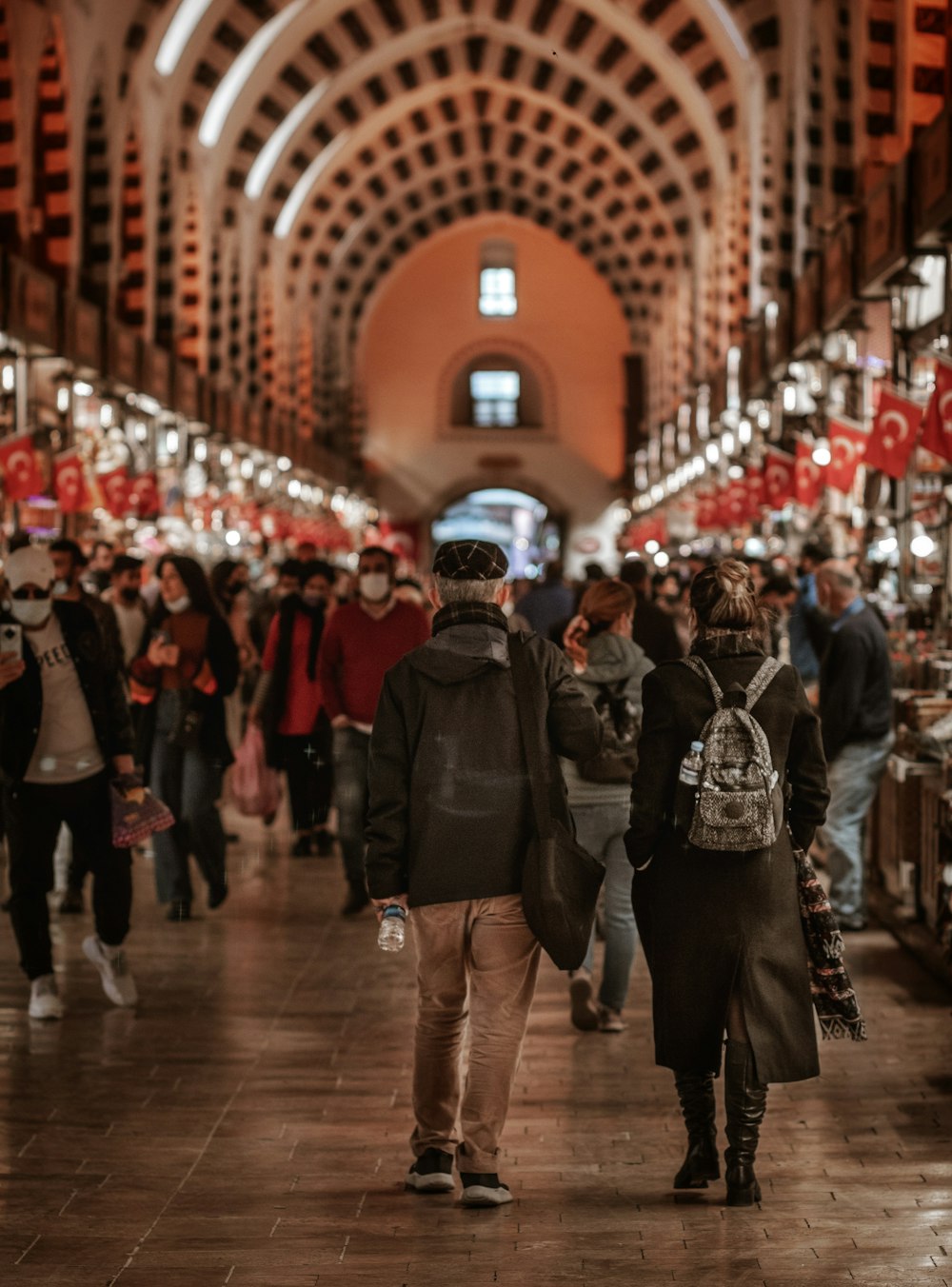 people walking on brown wooden floor