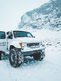white and black jeep wrangler on snow covered ground