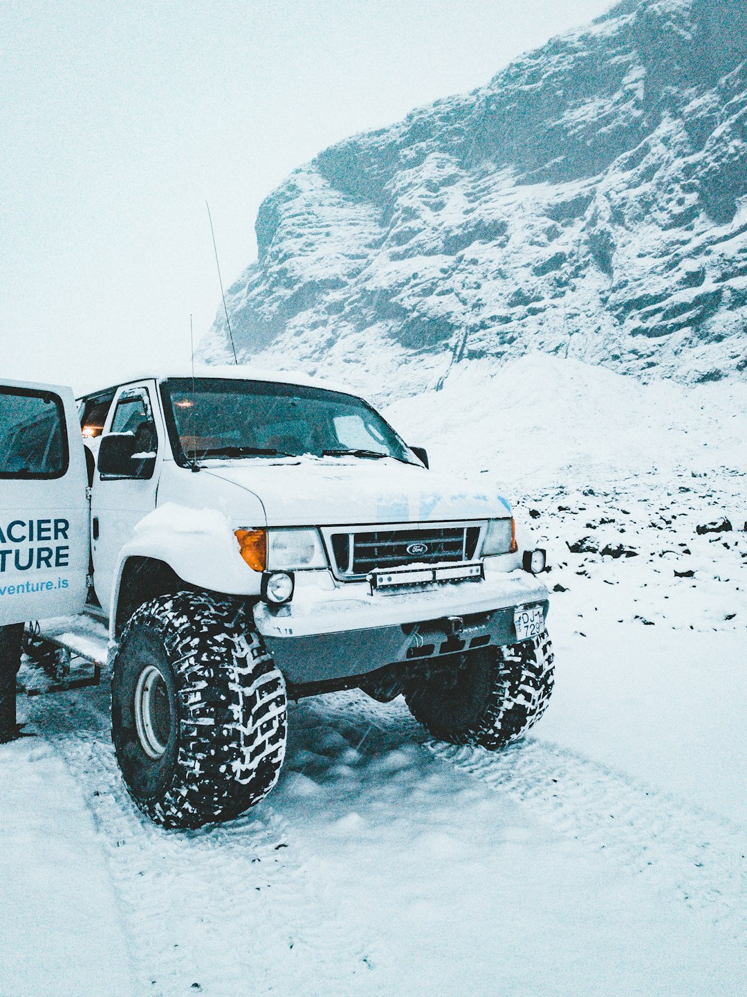 white and black jeep wrangler on snow covered ground