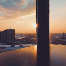 Elegant cityscape view from a high-rise office window at sunset.