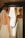 A joyful bride admiring her reflection in a mirror.