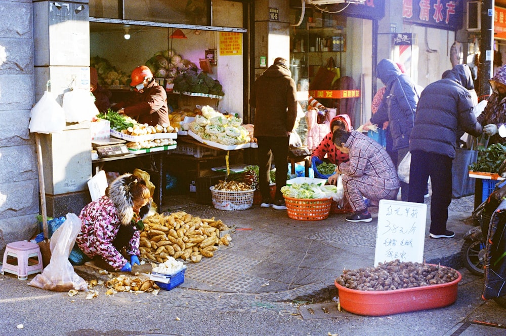 people in front of food stall during daytime