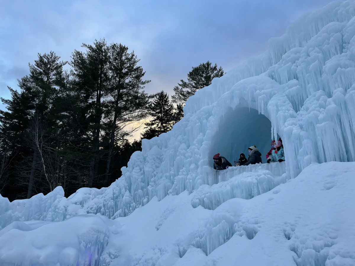 People riding on sled on snow covered ground during daytime