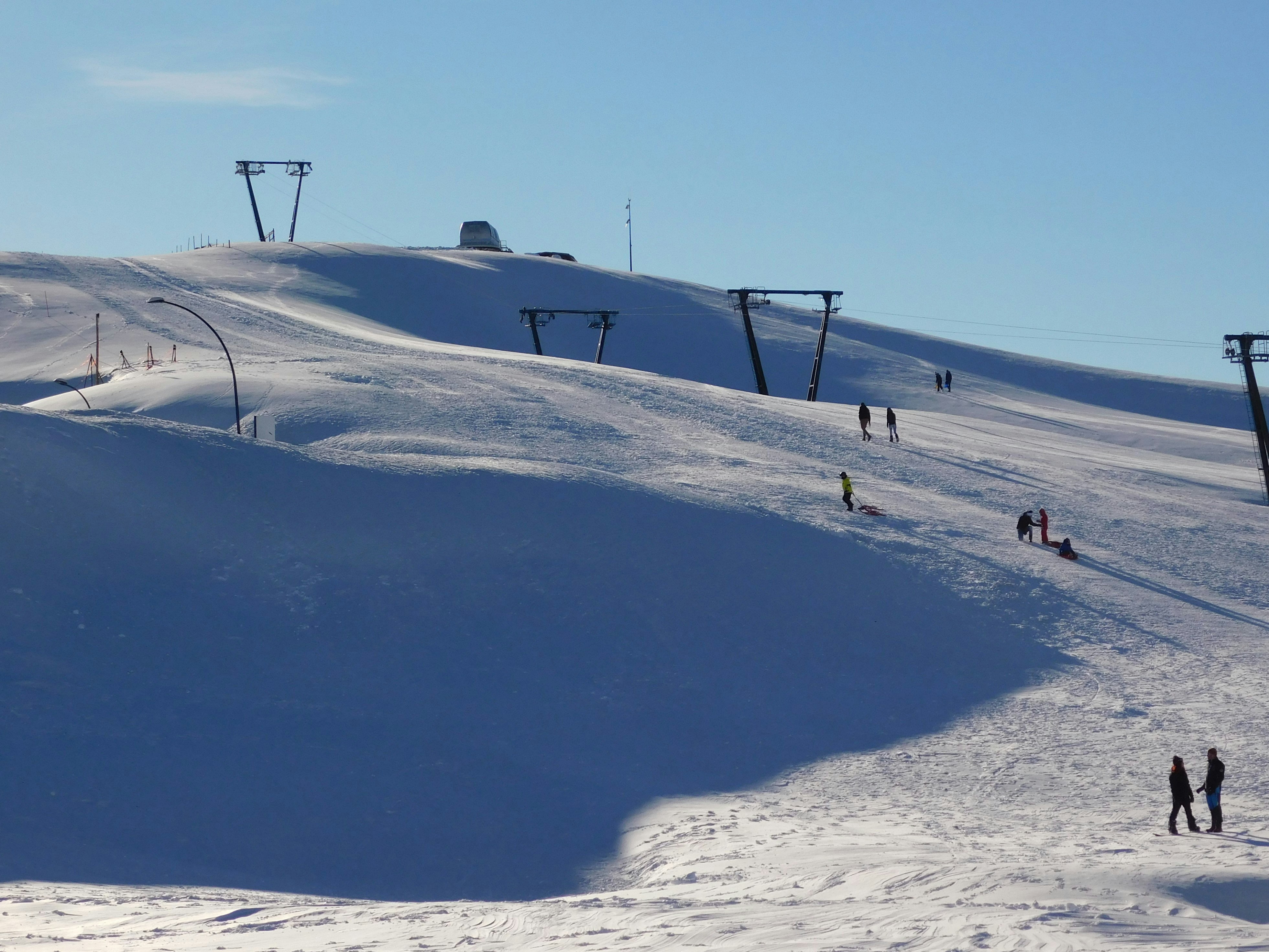people walking on snow covered field during daytime
