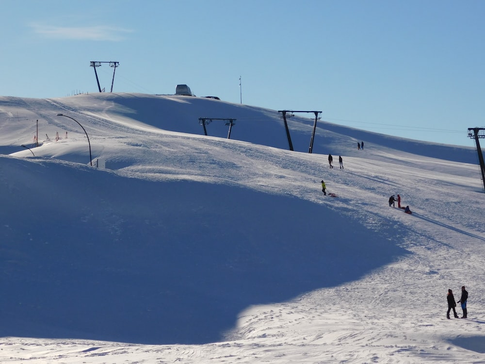 people walking on snow covered field during daytime