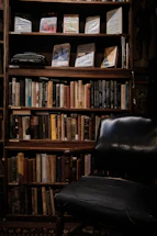 A warm, inviting reading nook bathed in soft cream light with a stack of books and a vintage typewriter.