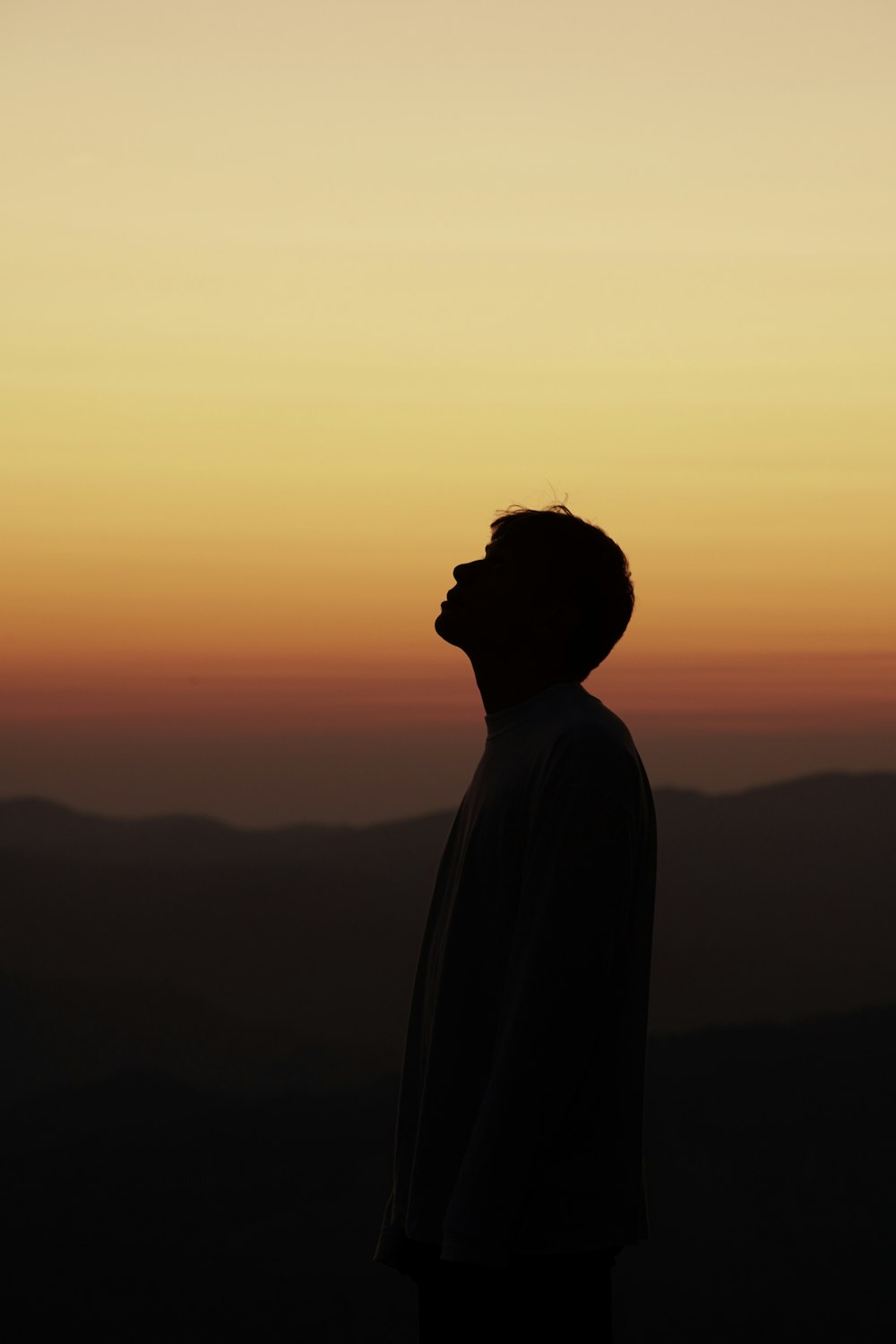 silhouette of person standing during sunset