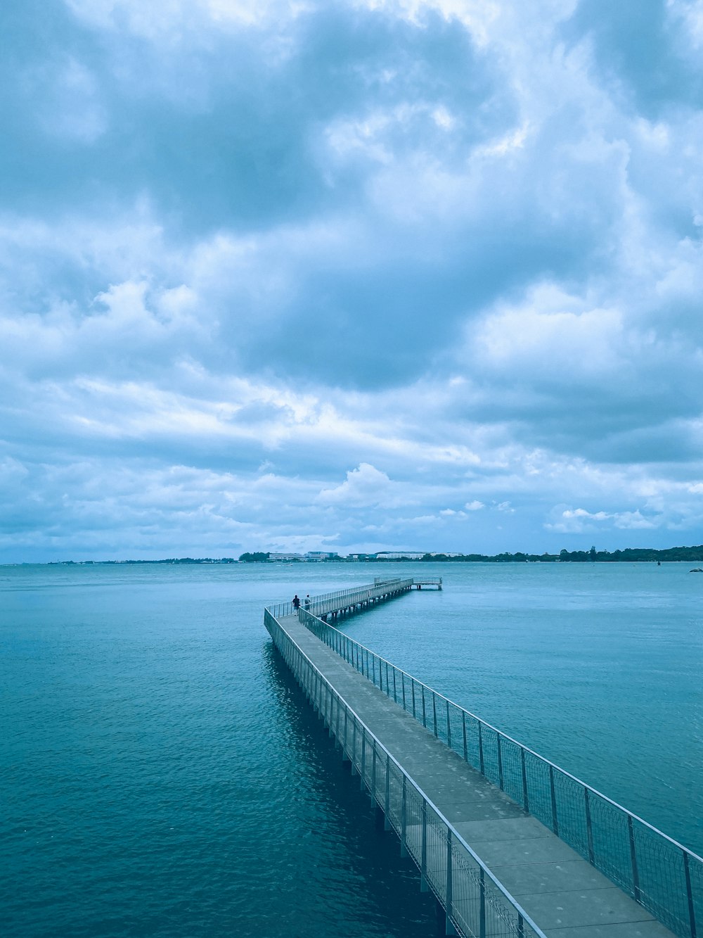 gray concrete dock under cloudy sky during daytime