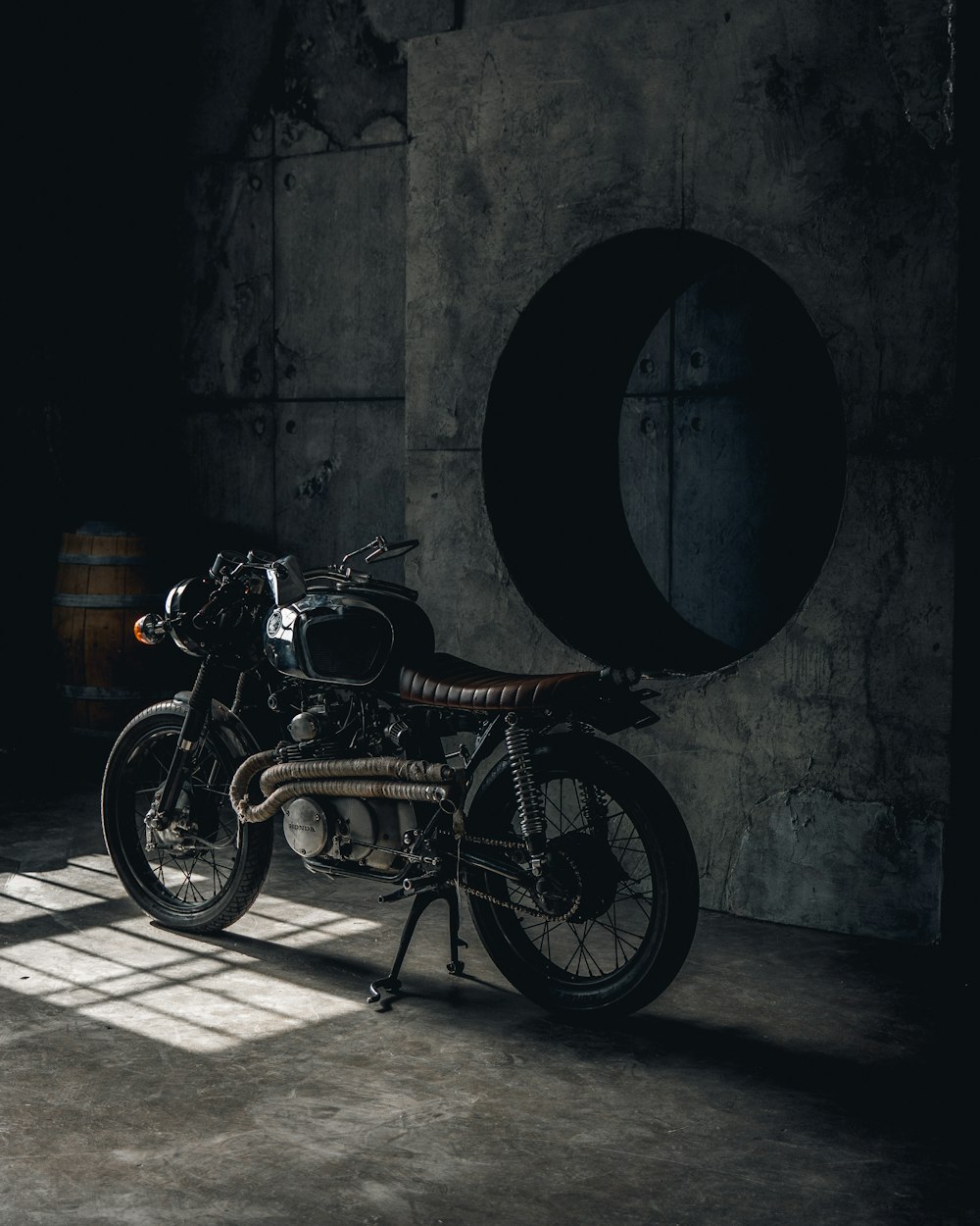 black commuter bike parked beside wall