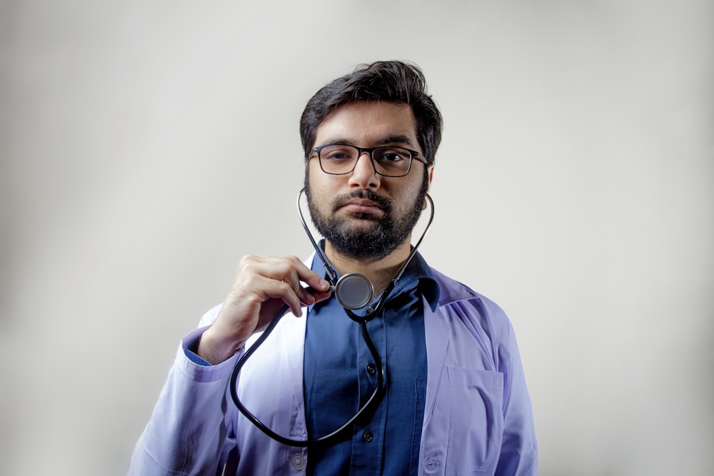 hombre con camisa de vestir azul con gafas de montura negra