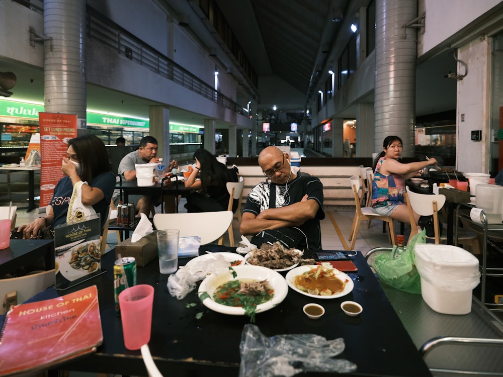 people sitting at the table eating