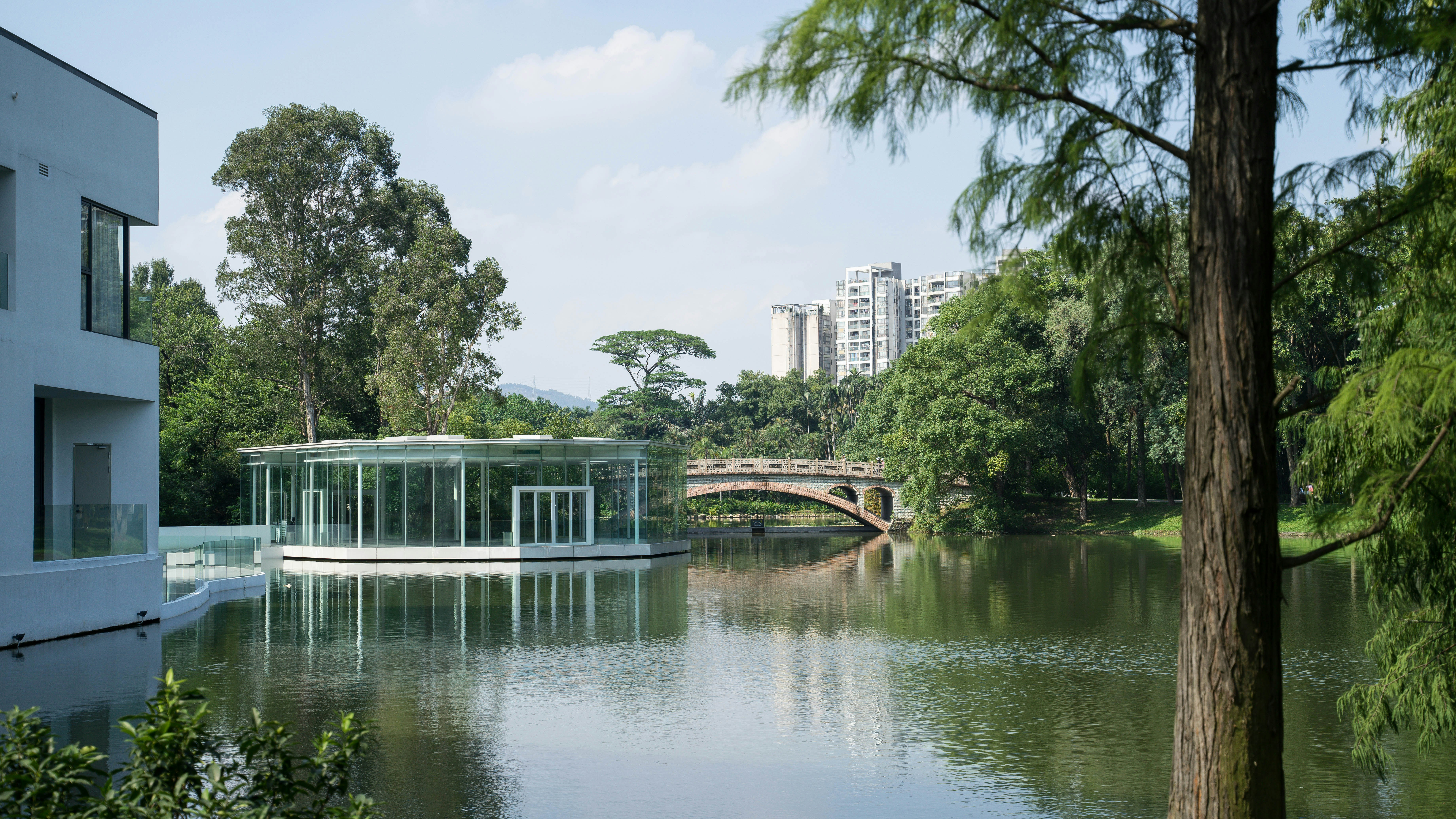 White concrete building near green trees and river during daytime photo ...