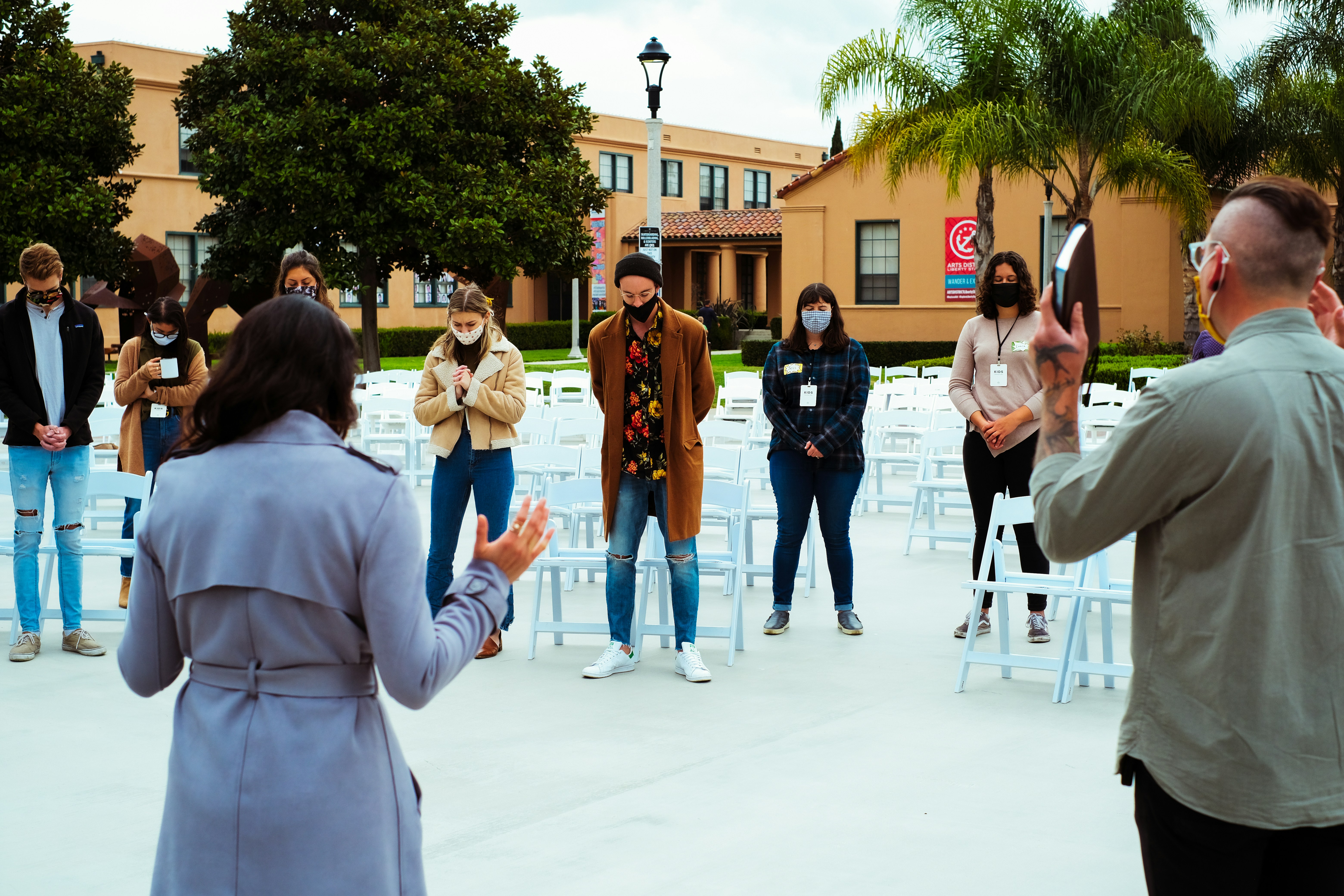group of people standing on gray concrete floor during daytime