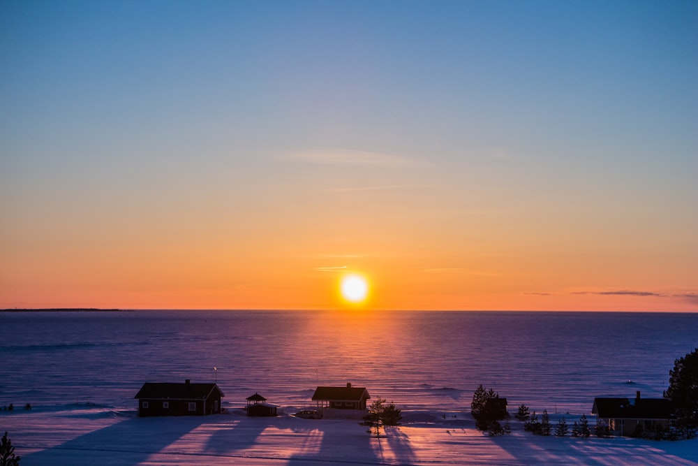 silhouette of people on beach during sunset