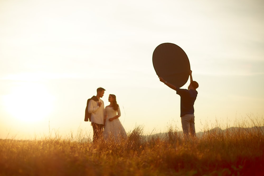 man and woman holding hands under the sun