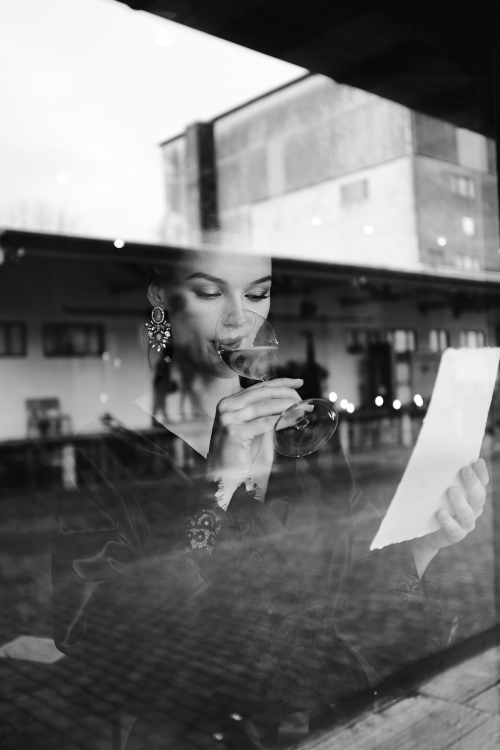 woman in black and white polka dot long sleeve shirt holding white printer paper