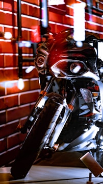 A sleek motorcycle accessory displayed on a rustic wooden table, highlighting its industrial design.