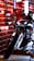 A sleek and glossy motorcycle is prominently displayed against a backdrop of red brick walls. The scene is enhanced with industrial lighting, creating intriguing reflections and highlights on the motorcycle's surface.