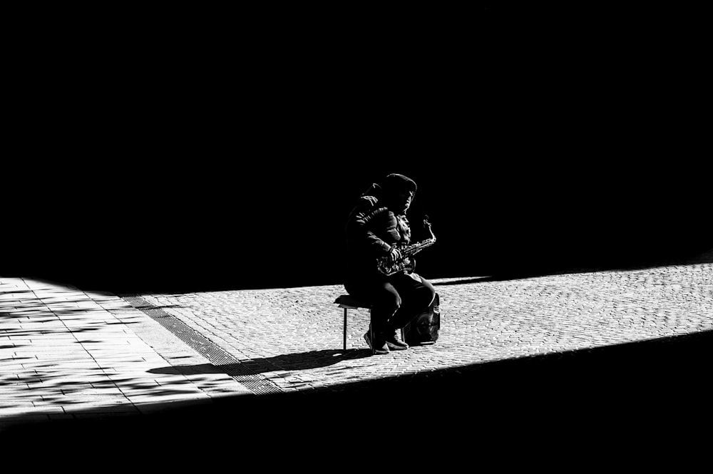 grayscale photo of woman sitting on floor