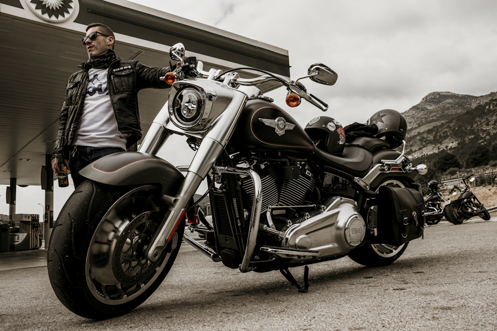 man in black jacket riding on black cruiser motorcycle