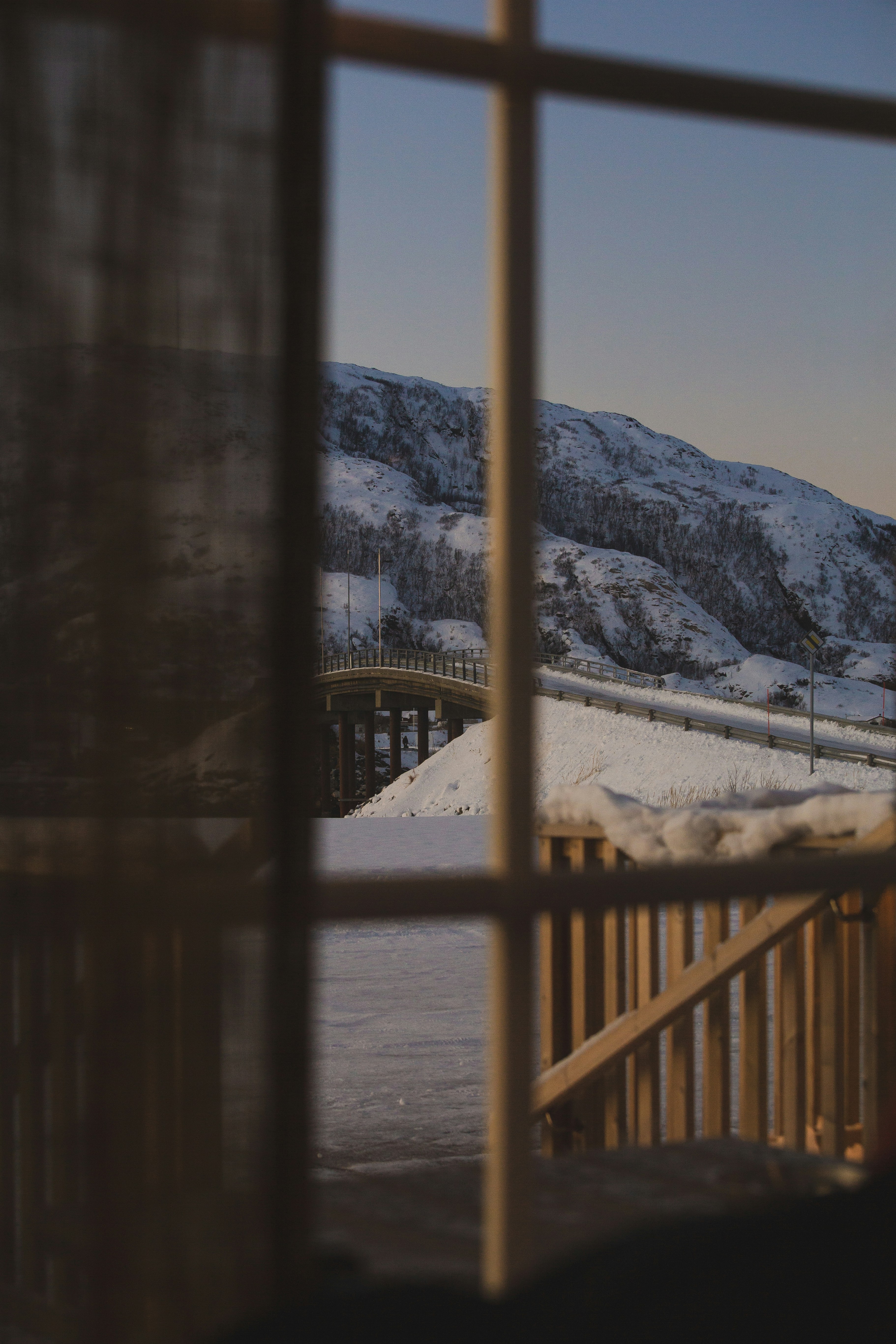 brown wooden fence near snow covered mountain during daytime