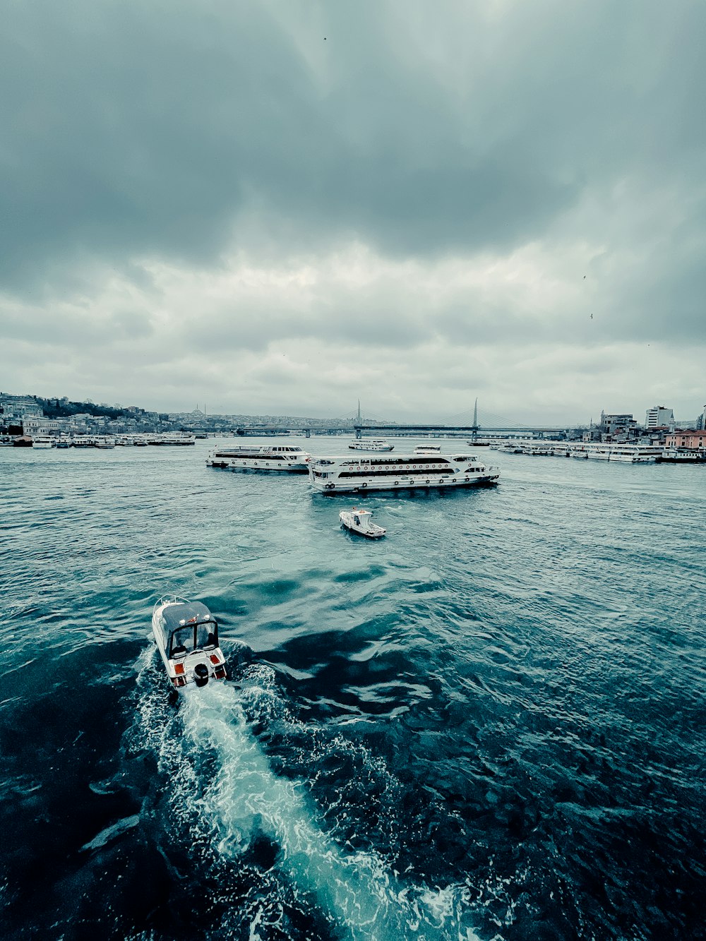 white and black boat on sea under white clouds during daytime