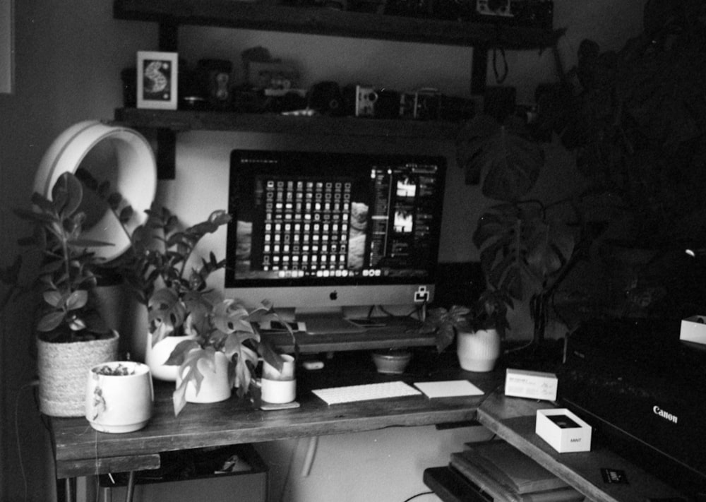 black flat screen computer monitor on white wooden desk