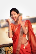 A joyful woman wearing rhodium plated daily wear jewellery, smiling in a bustling Kolkata street scene.