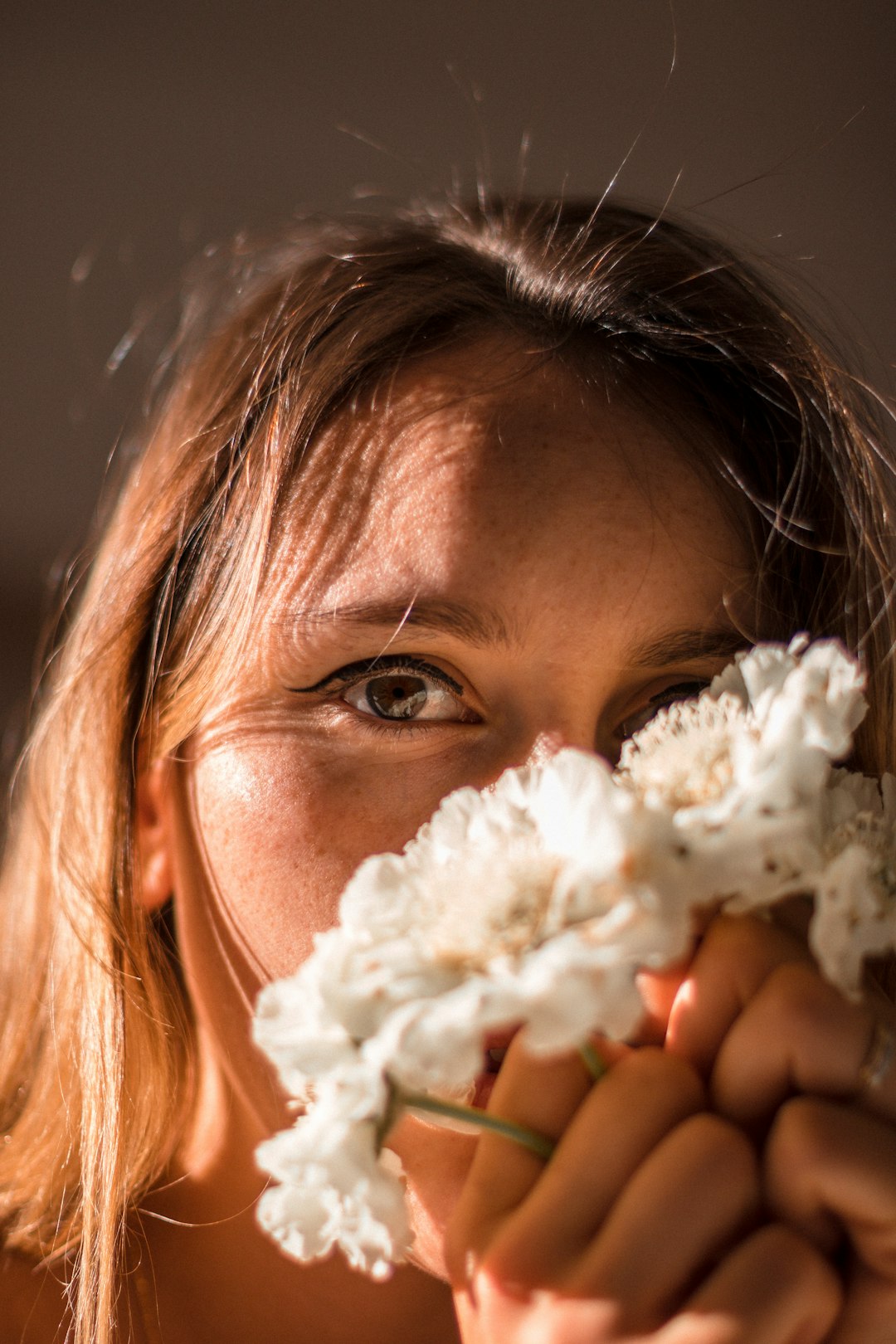 girl with white flower on her ear