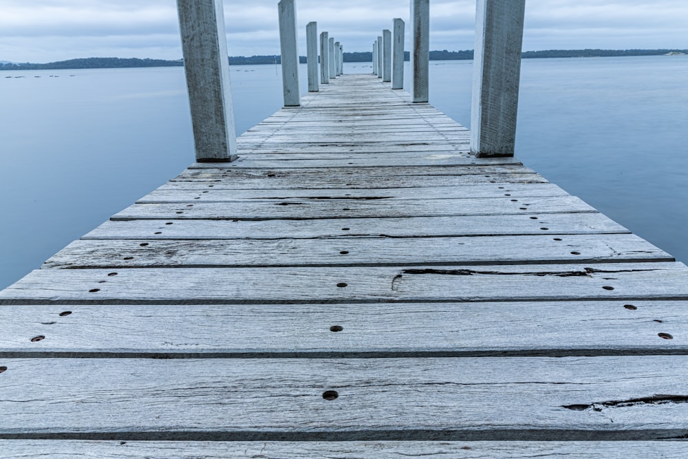 brown wooden dock on body of water during daytime