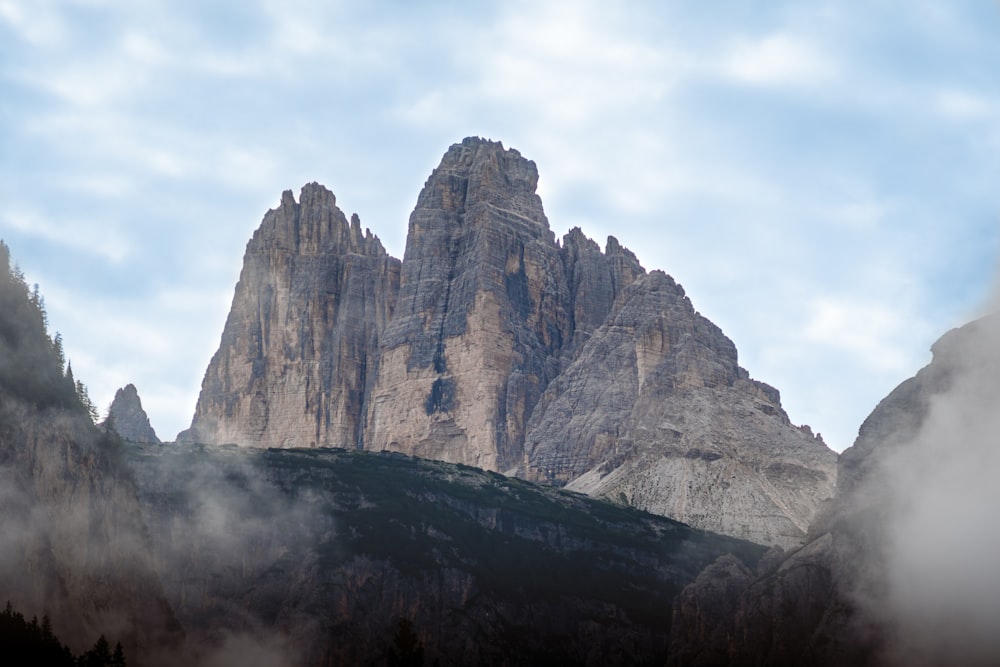 brown rocky mountain under white clouds during daytime