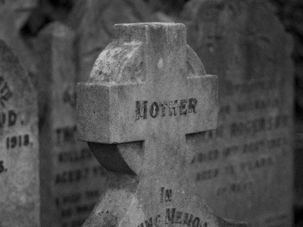 grayscale photo of concrete cross