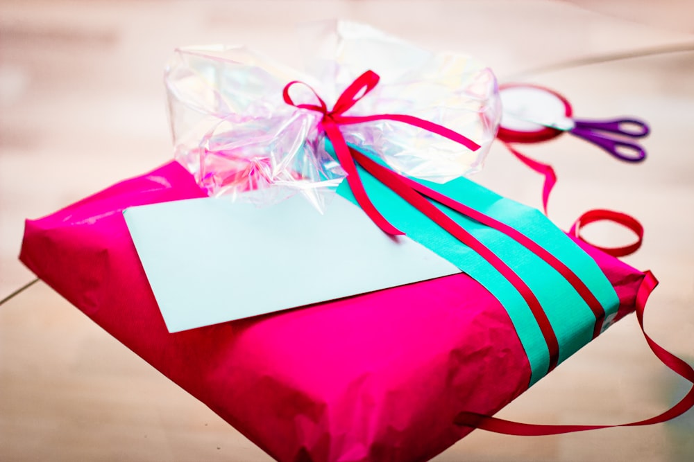 red and white gift box with white ribbon