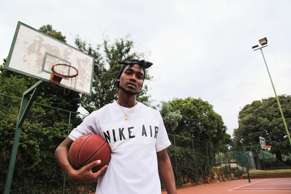 man in white and black crew neck t-shirt holding basketball