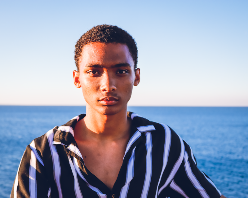 man in black and white striped polo shirt