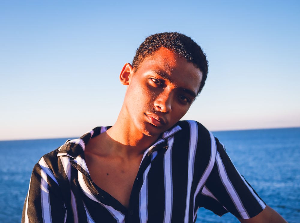 man in black and white striped shirt