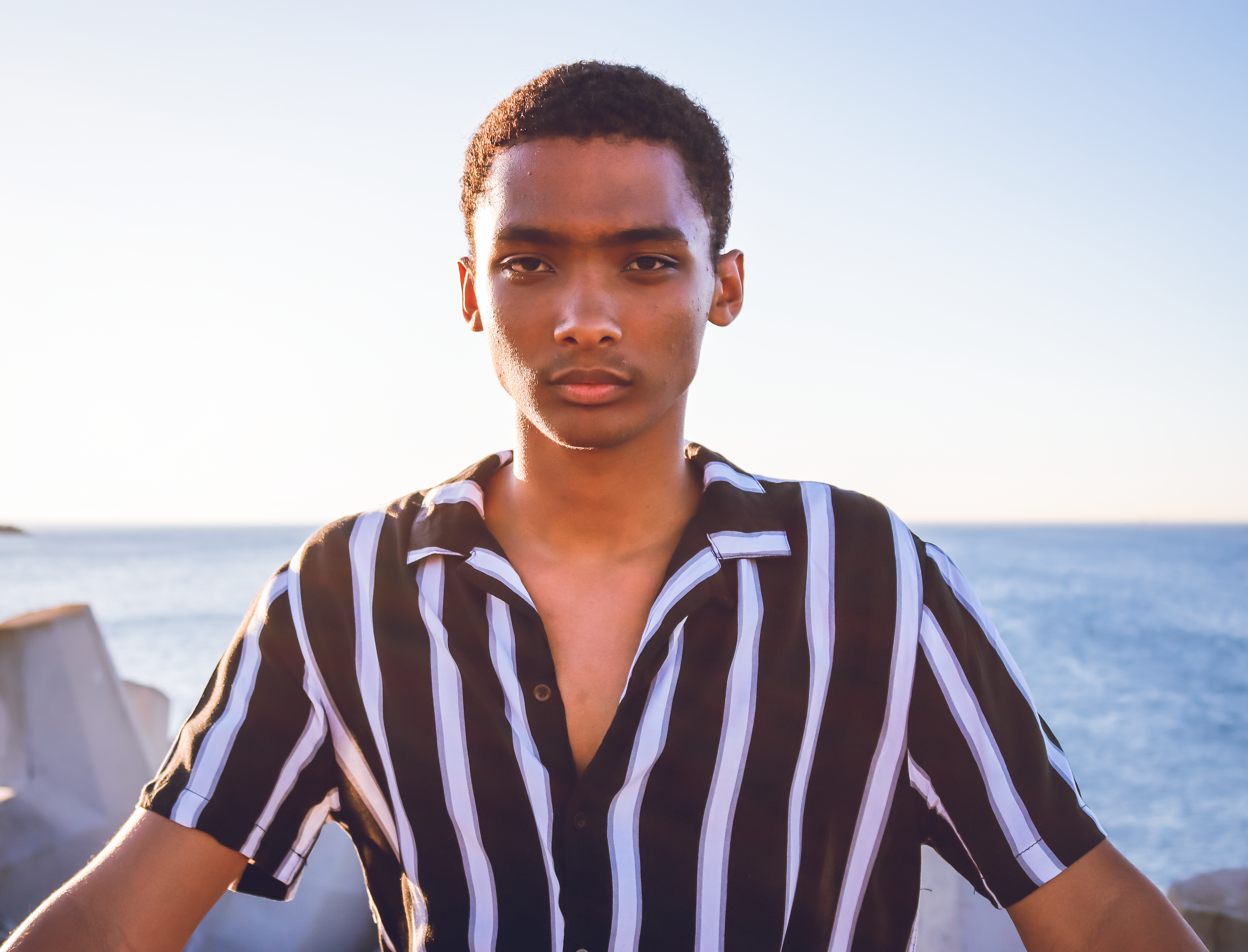 man in blue and white striped polo shirt