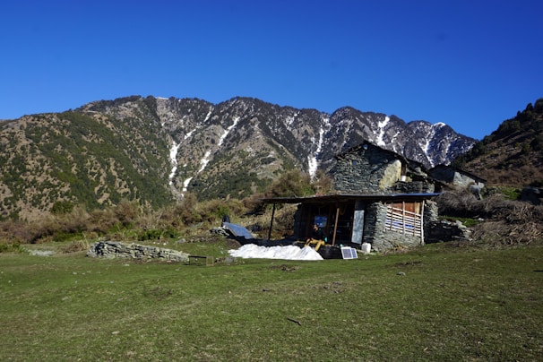 A rugged west coast home with solar panels and non-flammable battery units glowing softly at dusk.