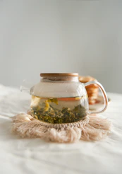 clear glass jar on white textile