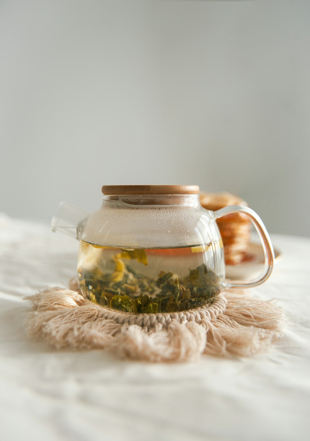 clear glass jar on white textile