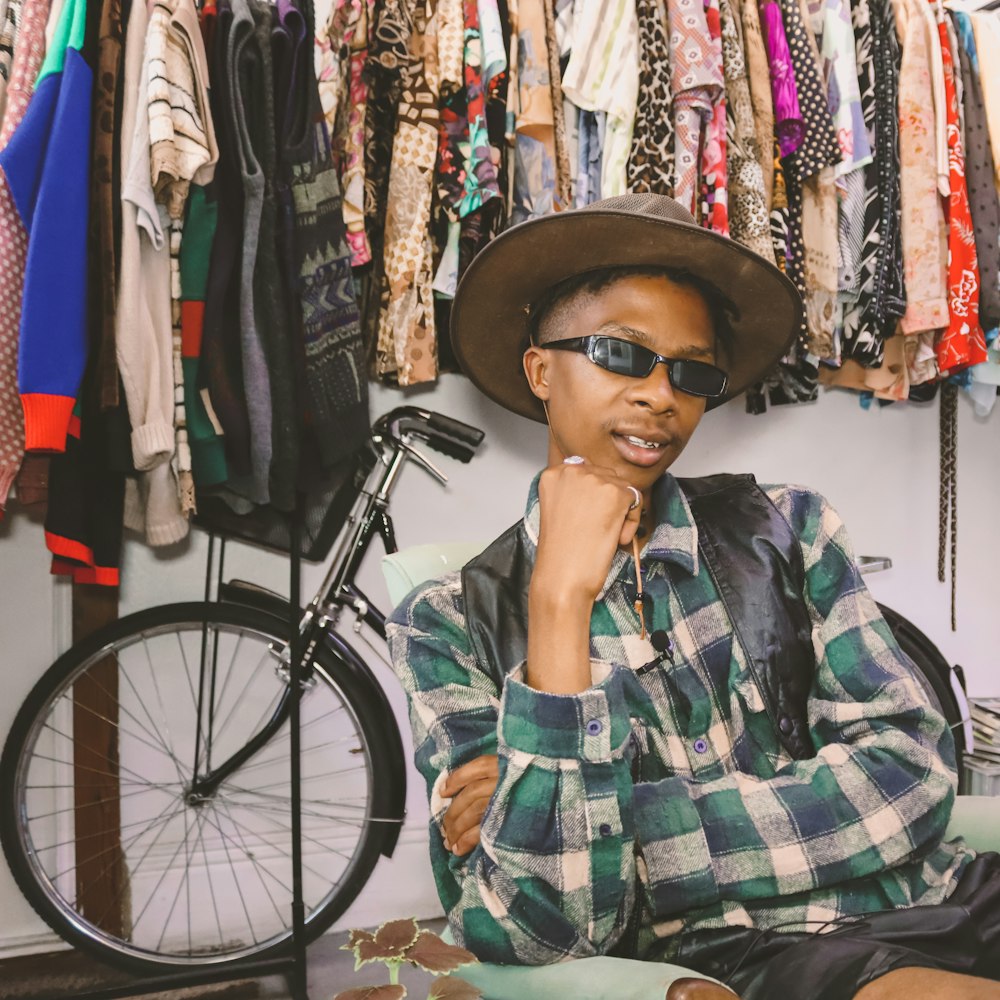 woman in green white and black plaid button up shirt wearing black hat