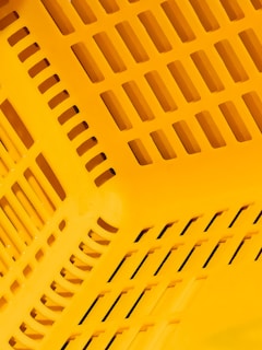 yellow plastic basket with blue plastic clothes hanger